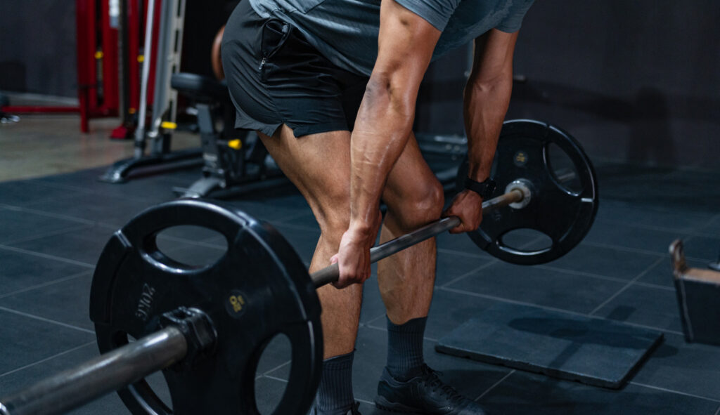 Athlete performing a barbell deadlift, the first event of the Army Fitness Test